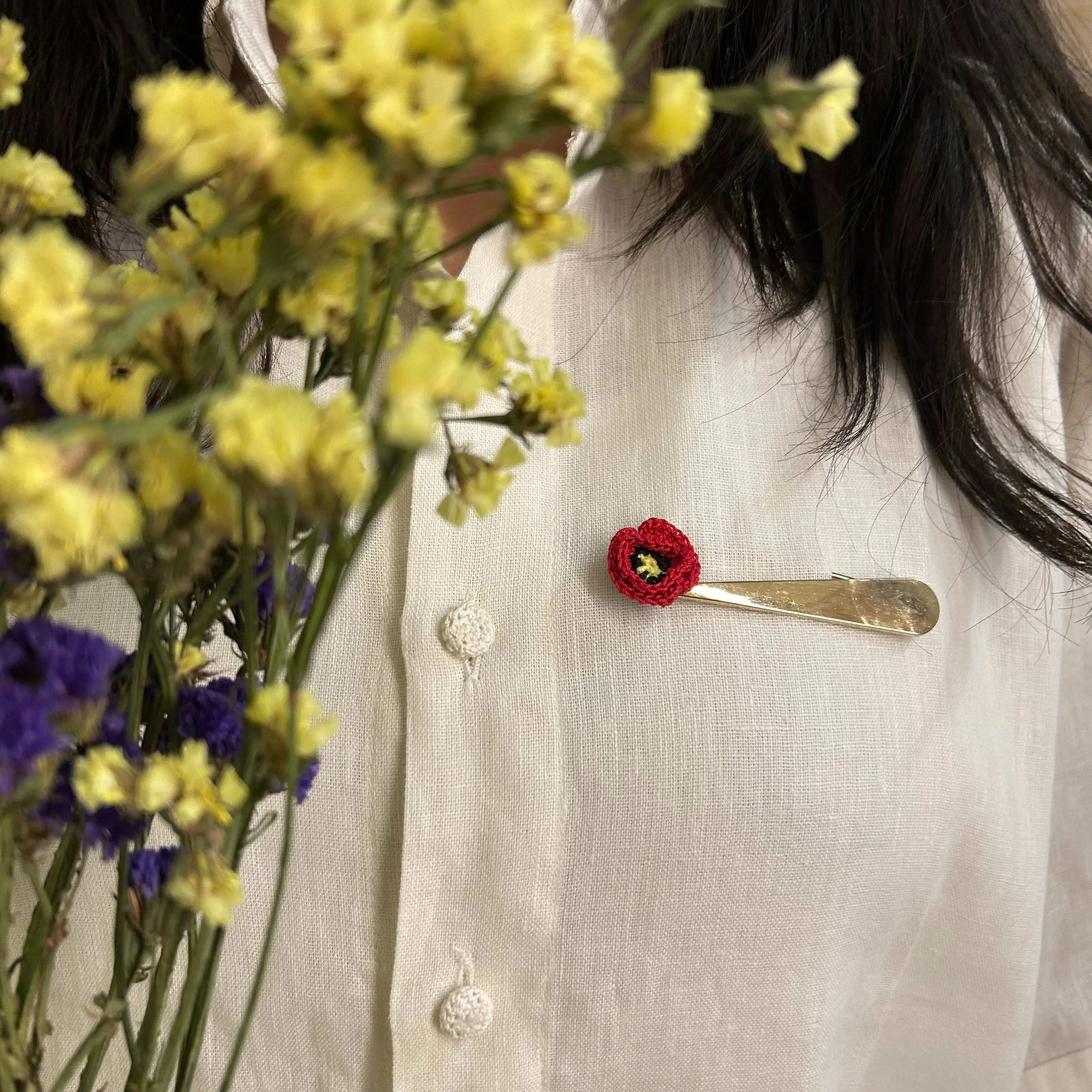 Poppy crochet brooch on a metal pin