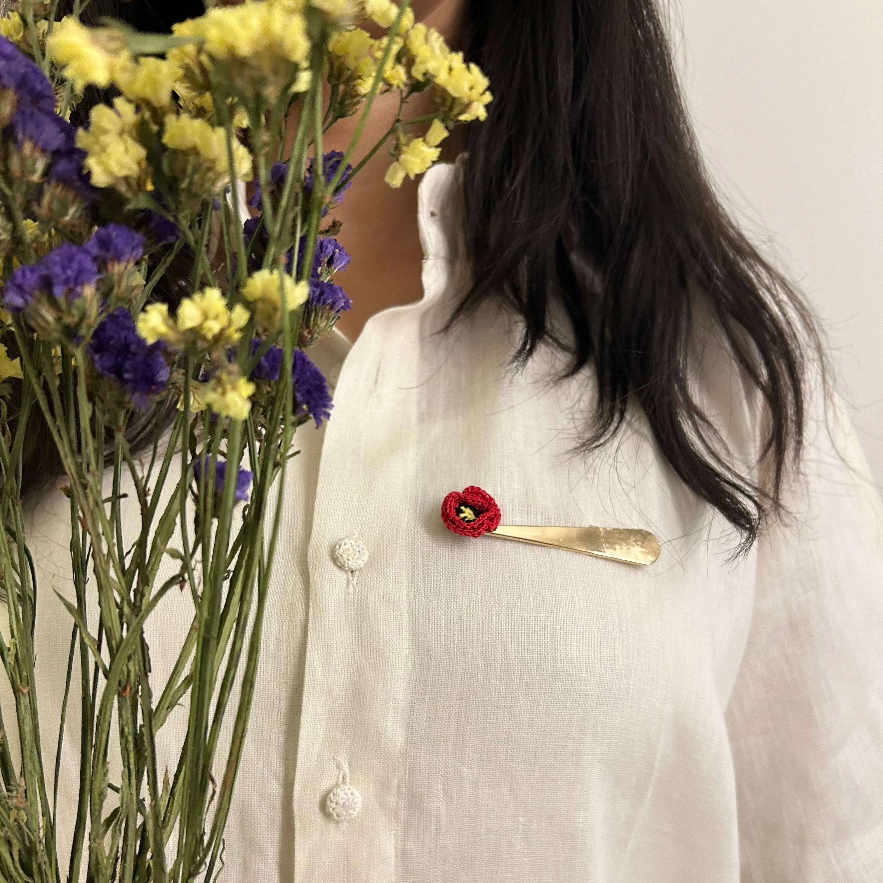 Poppy crochet brooch on a metal pin