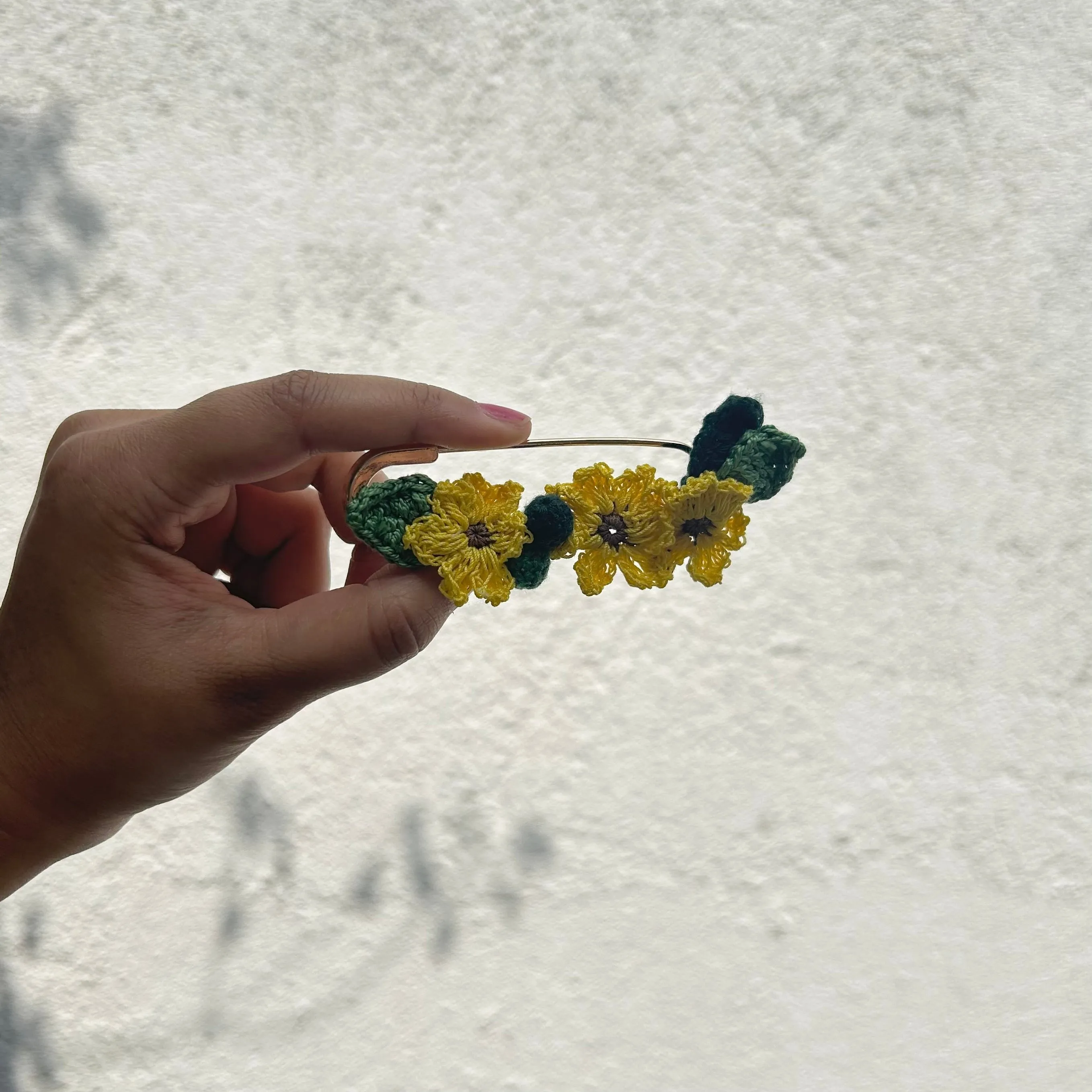 Sunflower crochet brooch on a metal pin