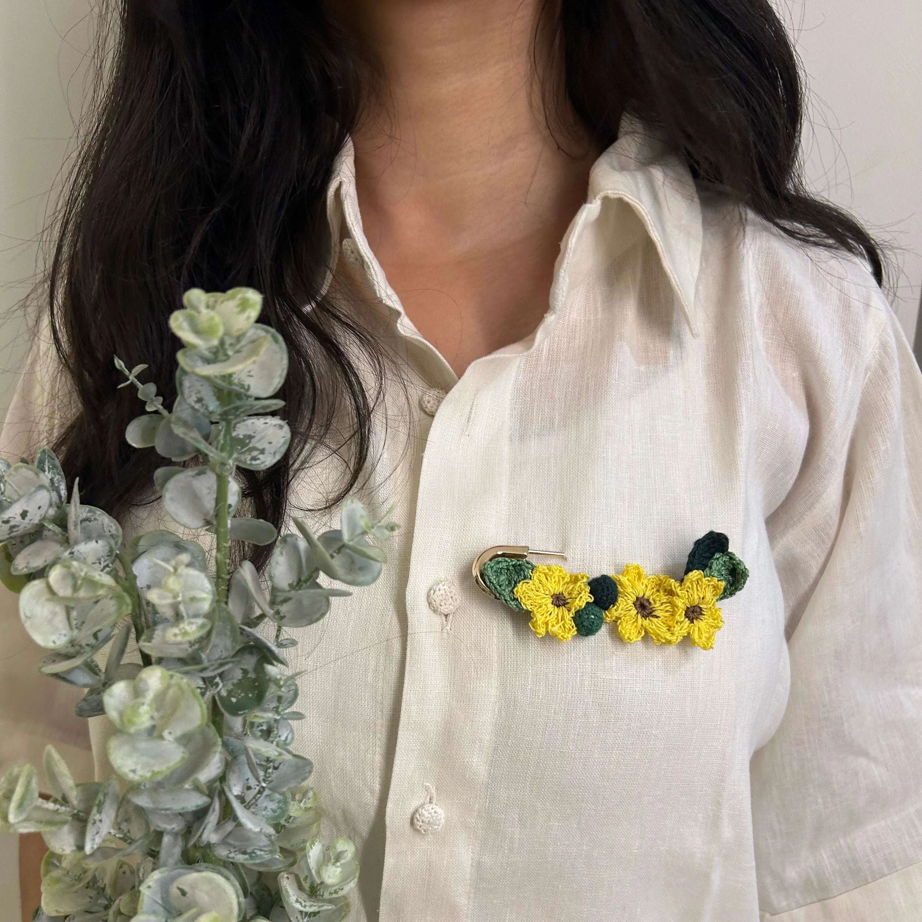 Sunflower crochet brooch on a metal pin