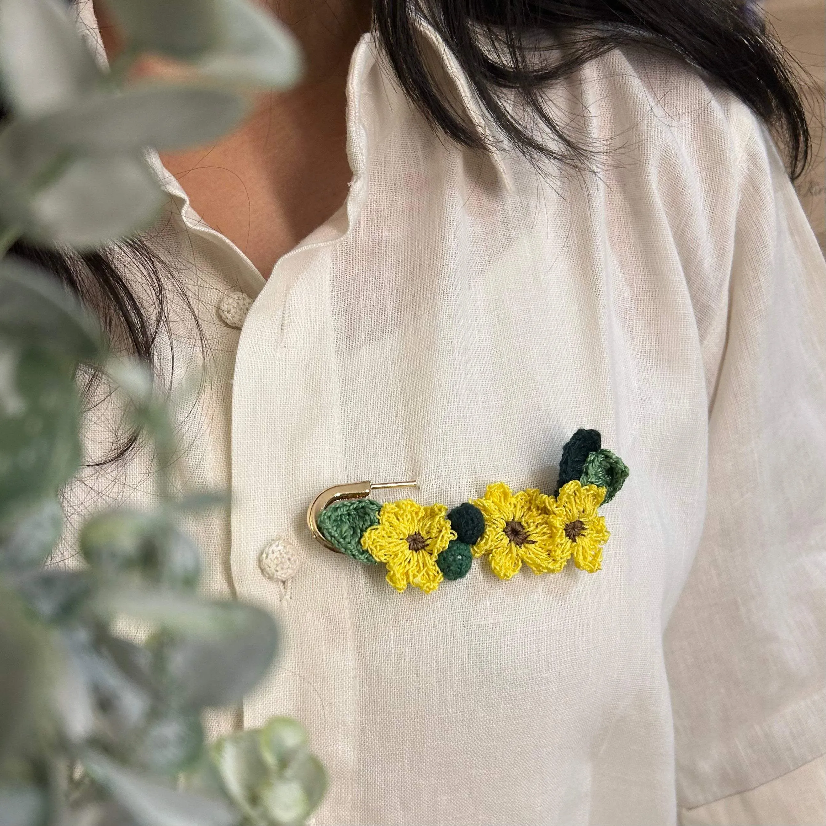 Sunflower crochet brooch on a metal pin